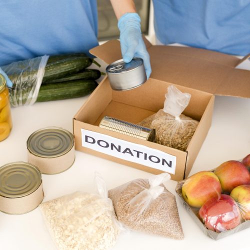 high-angle-charity-box-being-prepared-donation